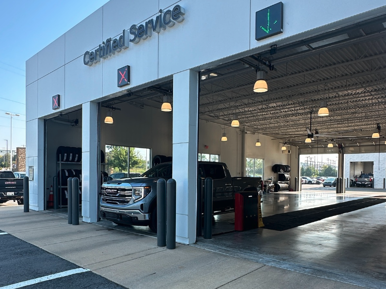 GMC trucks inside the Certified Service bays at Crain Buick GMC in Conway, Arkansas, ready for holiday travel inspections